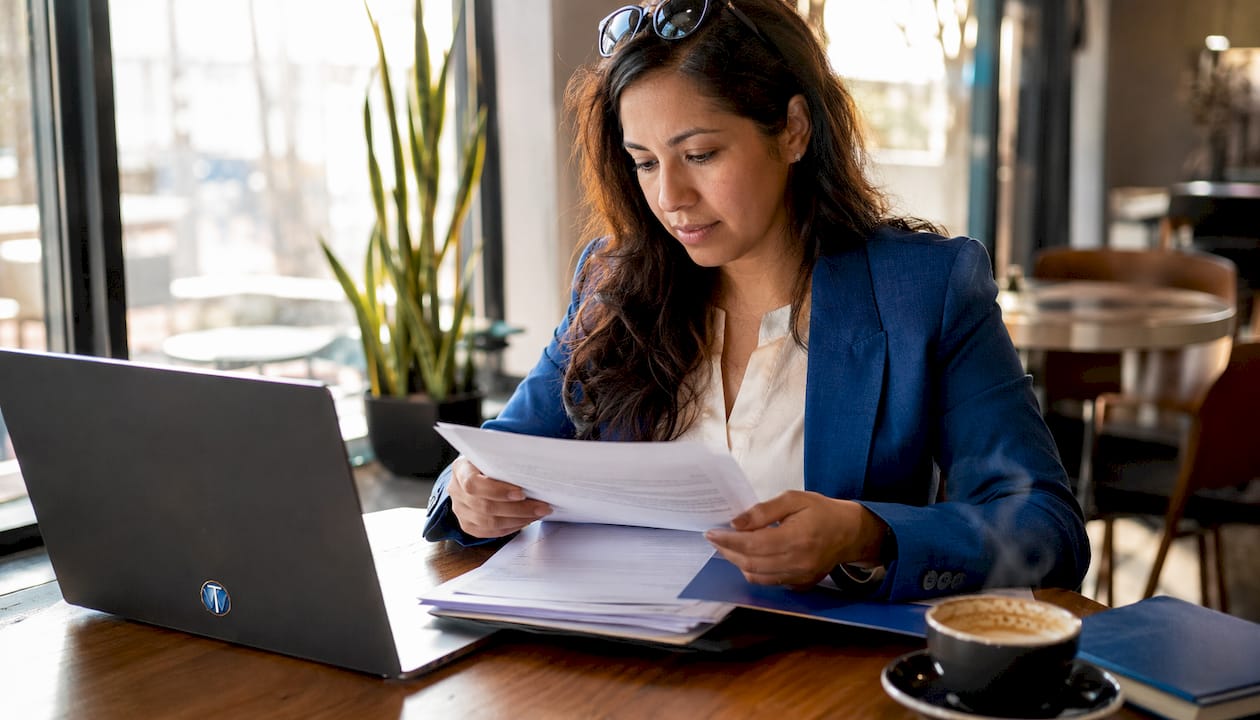 Consultant reviewing AI web design compliance papers
