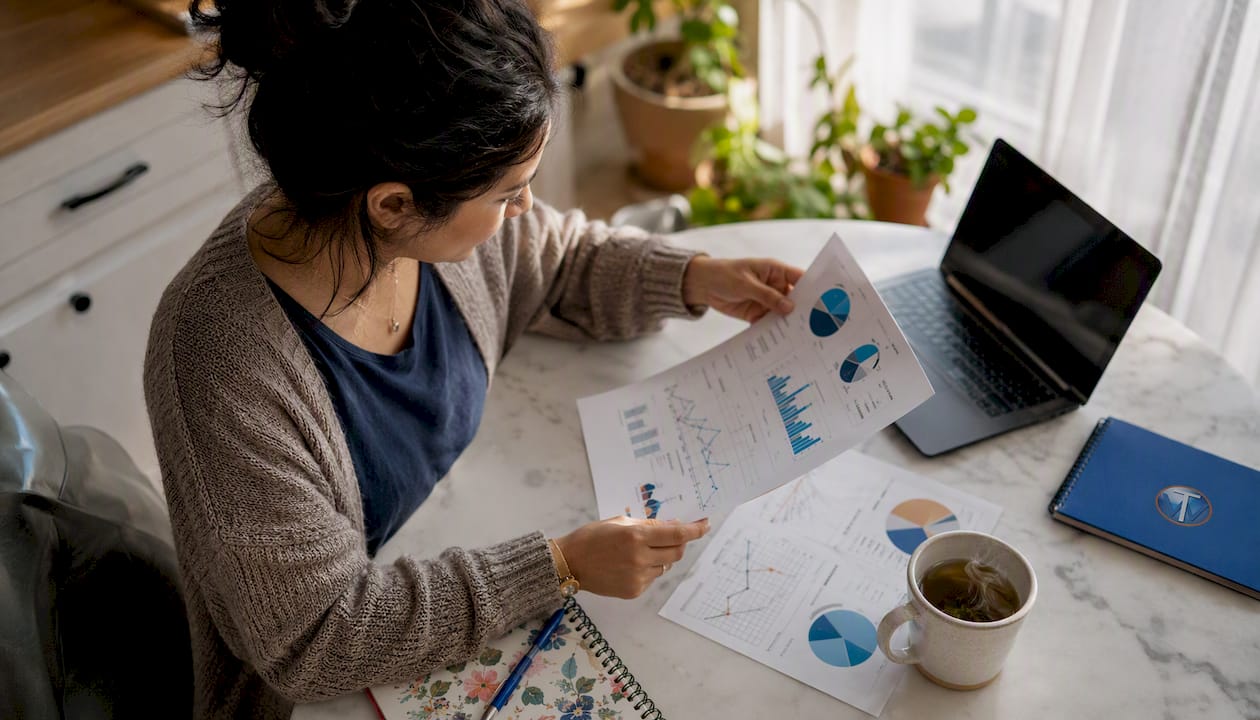 Hands reviewing digital ad data charts