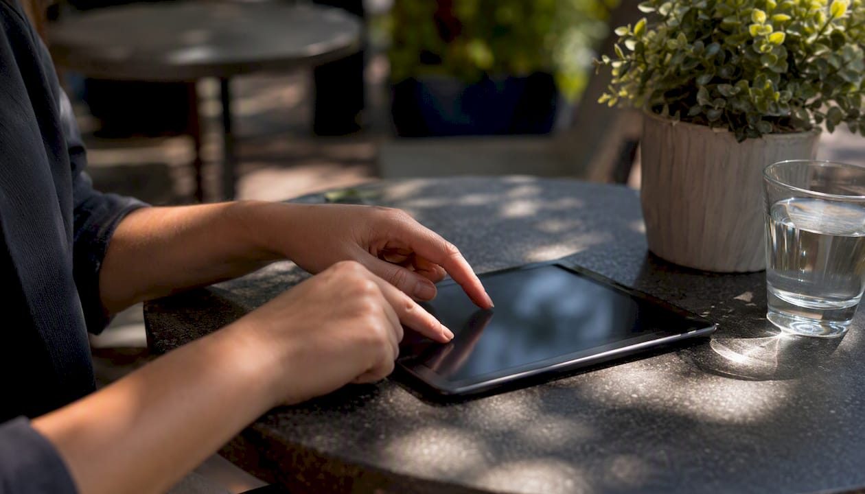 Hands interacting with tablet adjusting chatbot