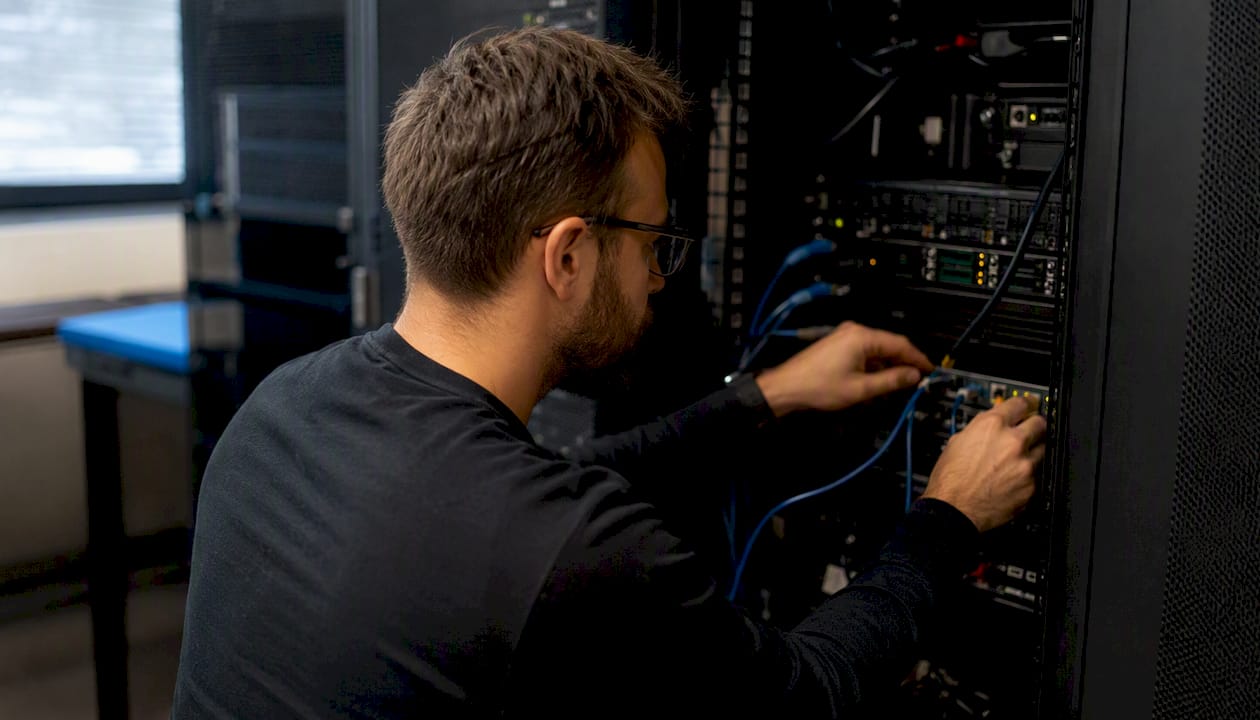 Hands adjusting servers processing cookieless analytics