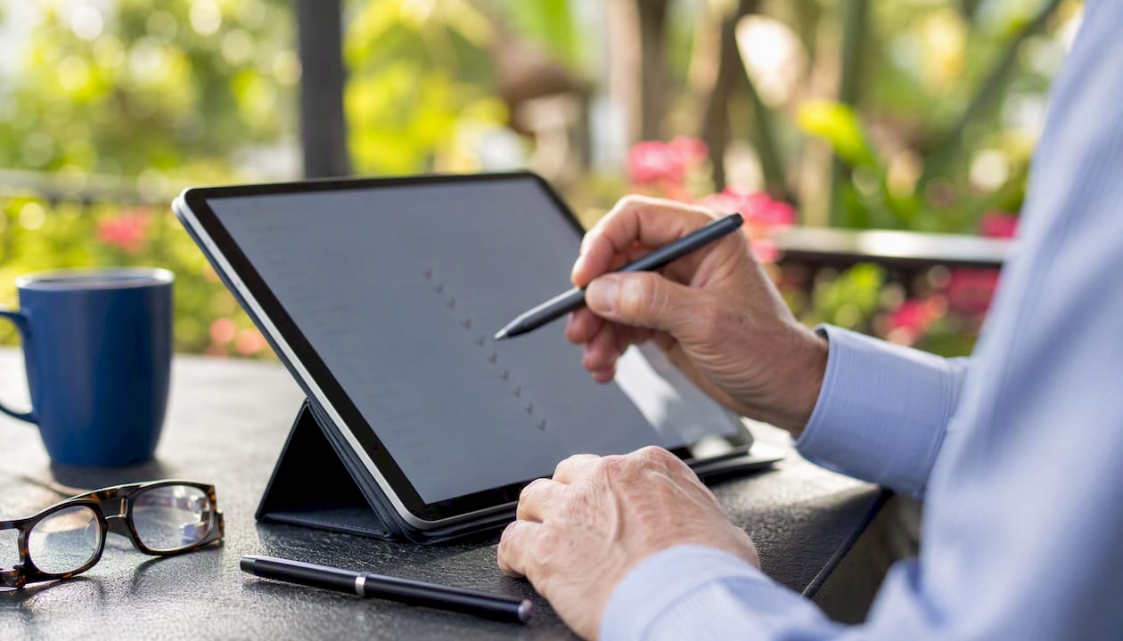 Hands conducting security compliance audit on tablet