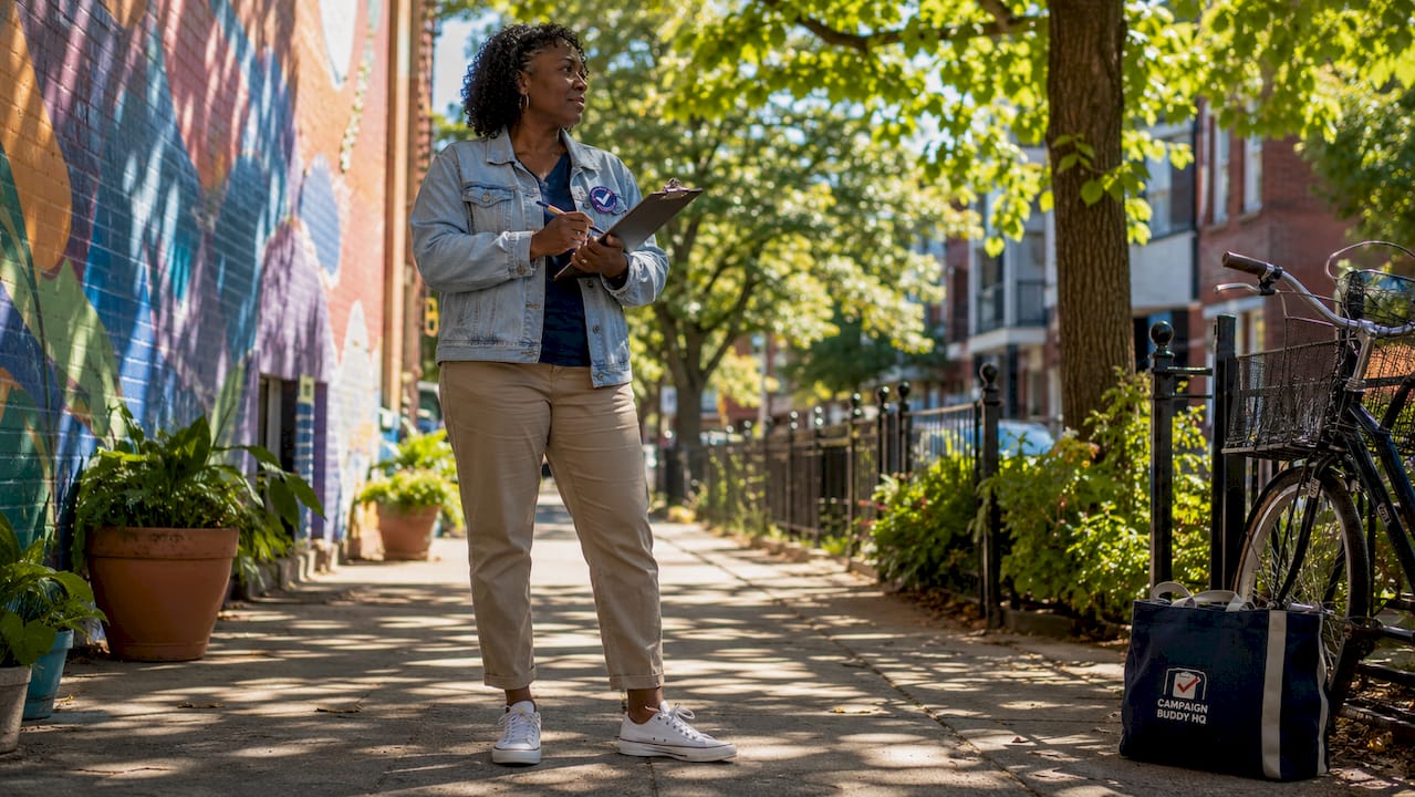 Canvasser outdoors with clipboard at house