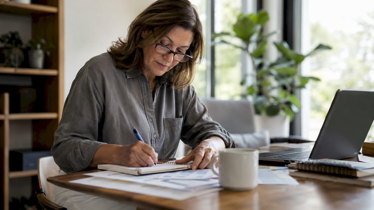 Small business owner reviewing financial notes
