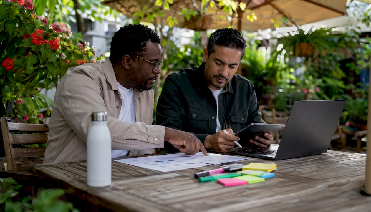 Two men collaborating on usability testing feedback