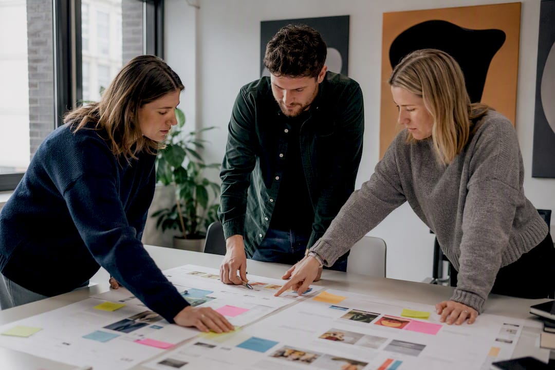 Hands arranging marketing notes on table