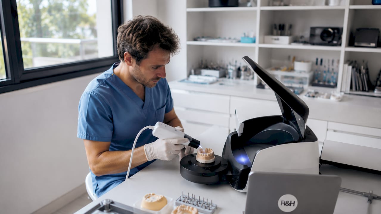 Hands using digital intraoral scanner
