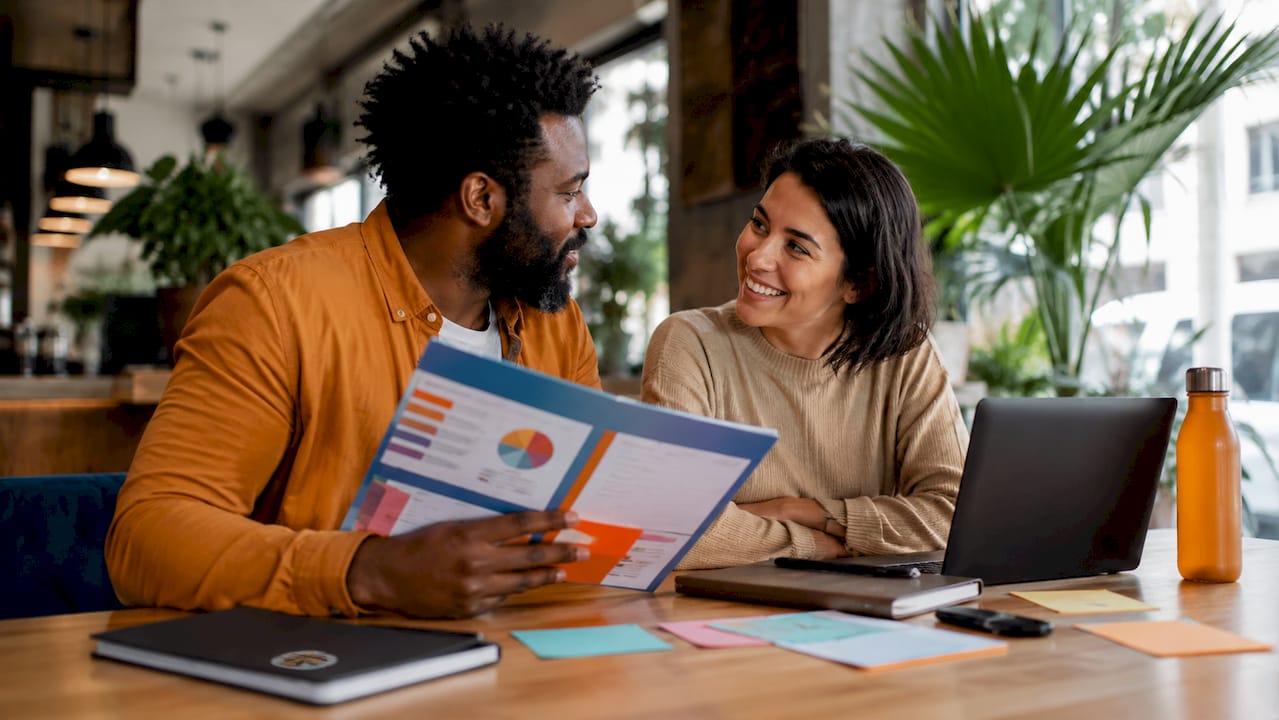 Two business owners discussing brand performance