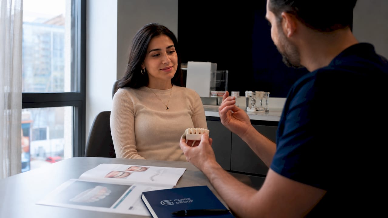 Patient consulting dentist about dental bridge