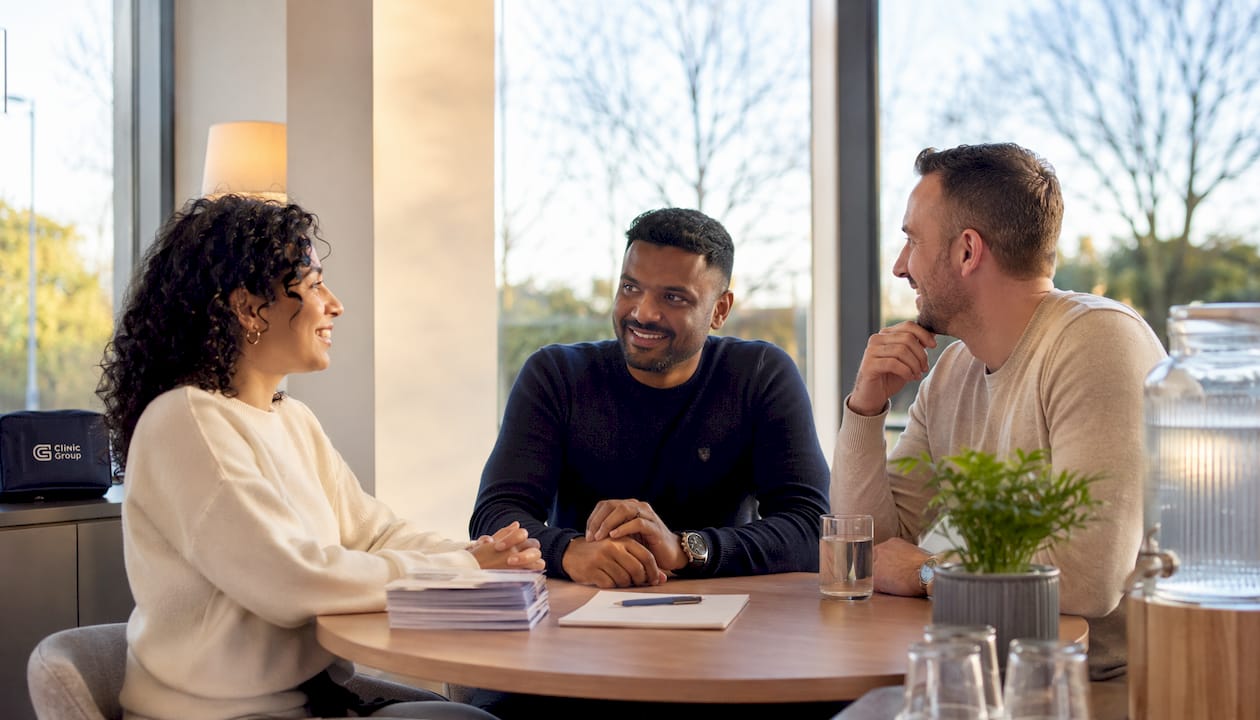 Diverse patients in bright clinic consultation room