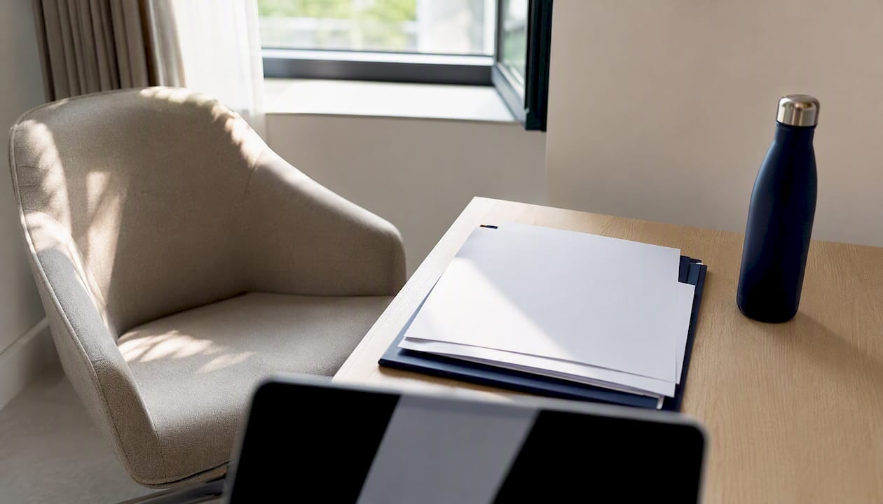 Desk with aftercare policy documents and clinical badge