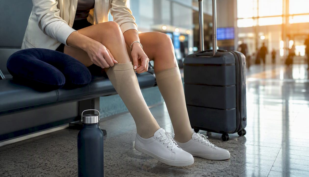 Traveler wearing compression stockings in airport terminal