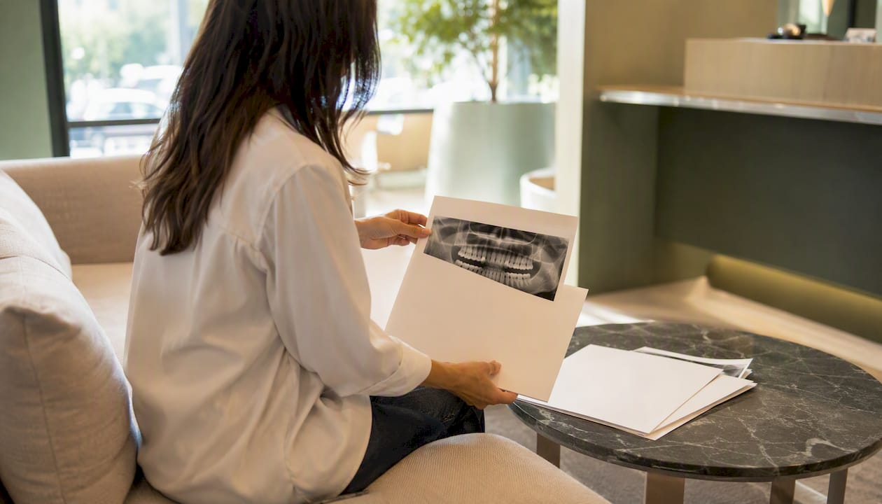 Patient placing dental reports for consultation