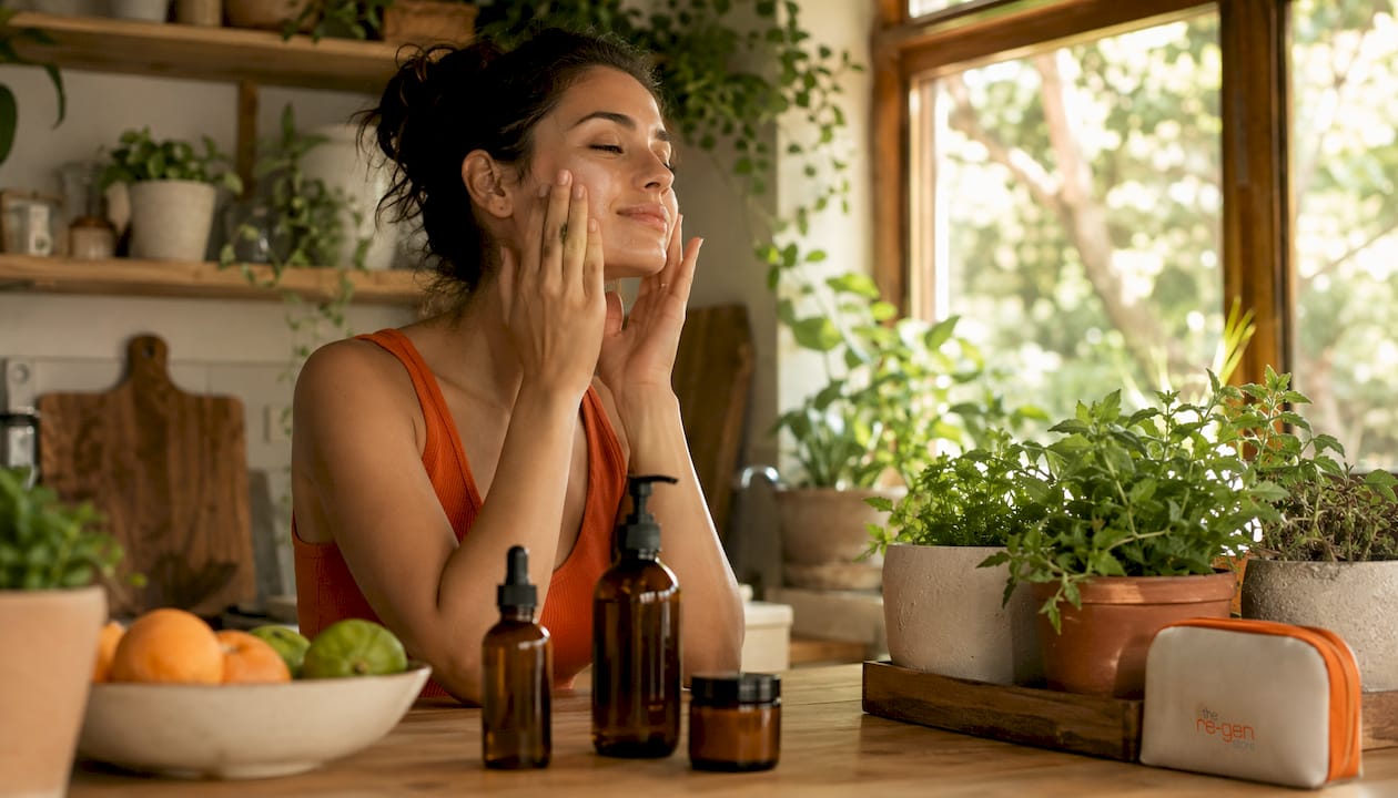 Woman applying natural facial serum in bathroom