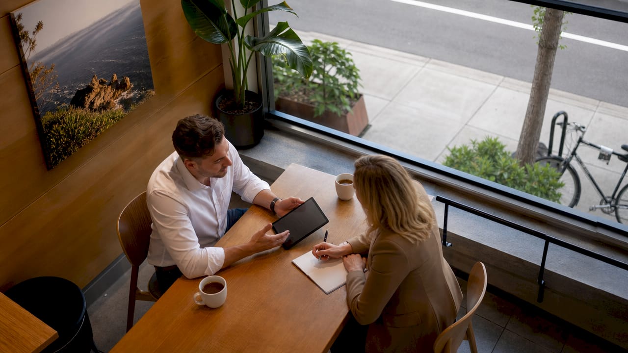 Seller consulting real estate agent in office