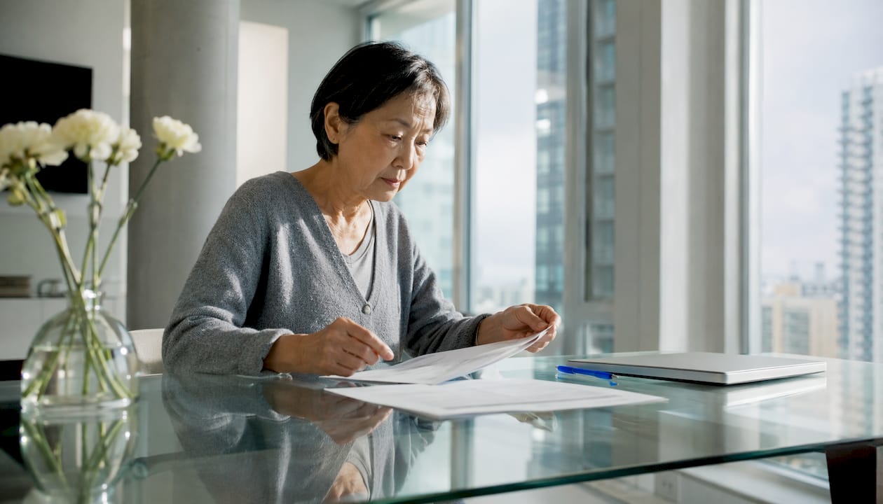 Woman reviewing credit documents at table