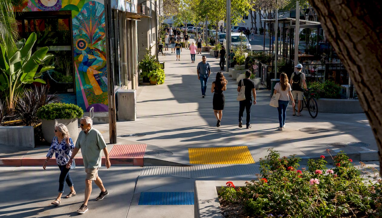 Pedestrians using accessible sidewalk and infrastructure