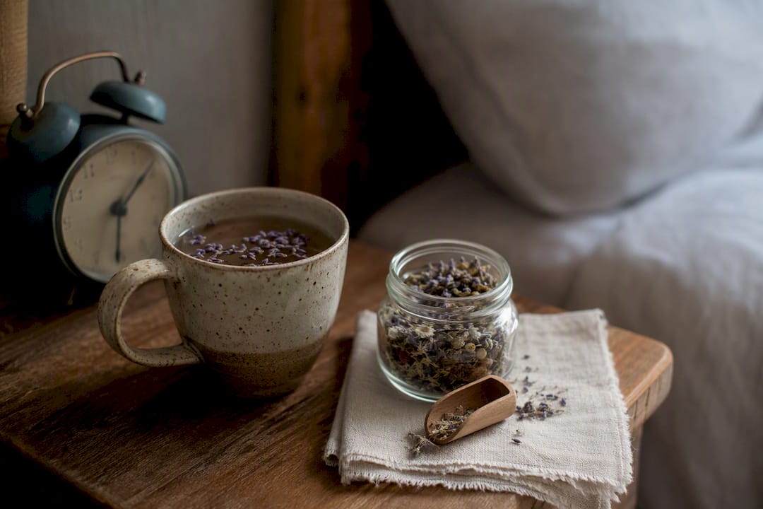 Bedside herbal sleep support setup with tea and powder