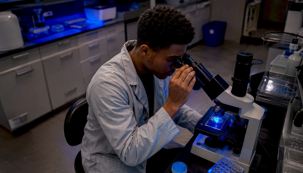 Researcher using microscope for membrane studies