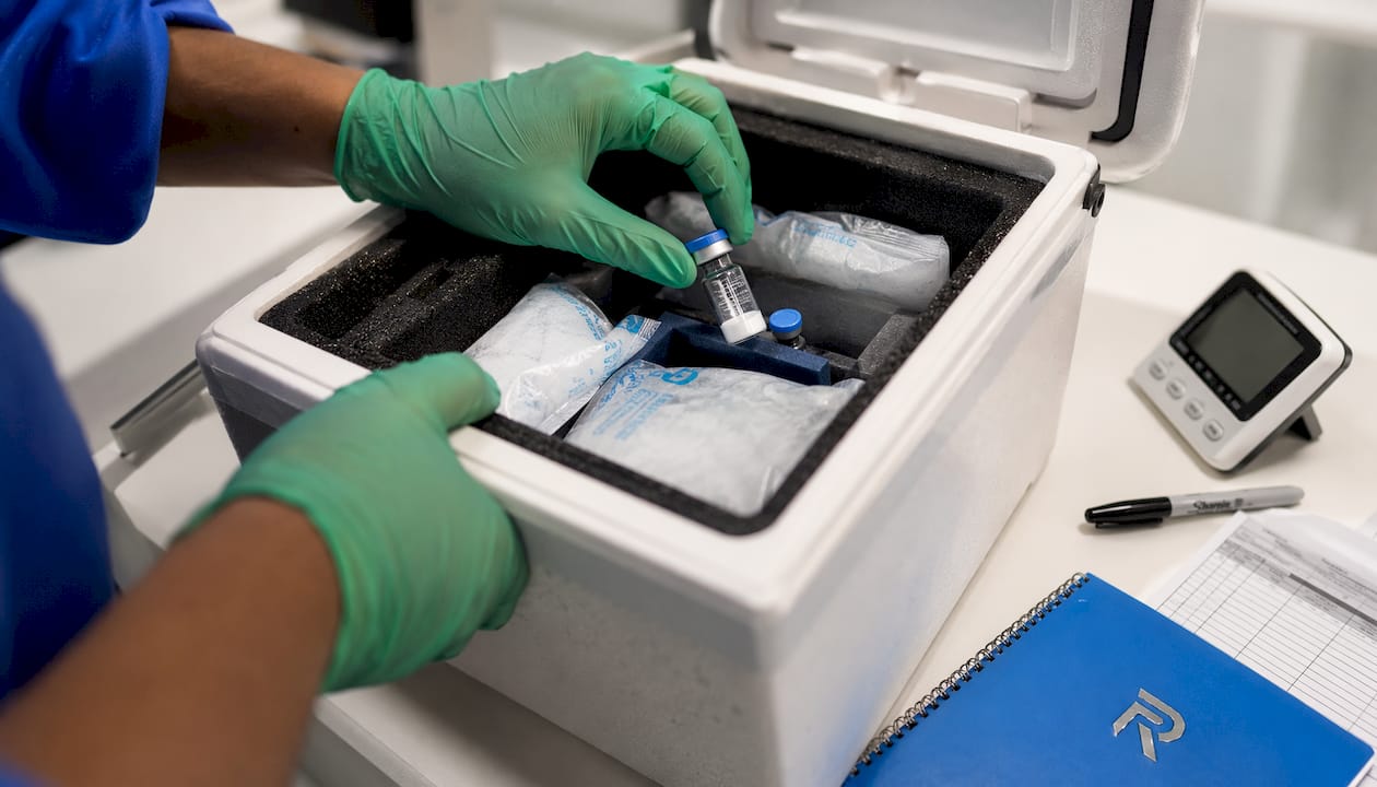 Hands packing peptide sample with cold packs