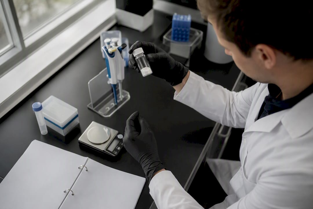 Scientist handling peptide salt vial