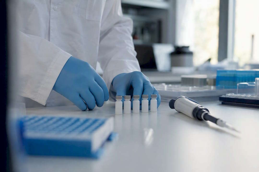 Lab hands checking peptide vials