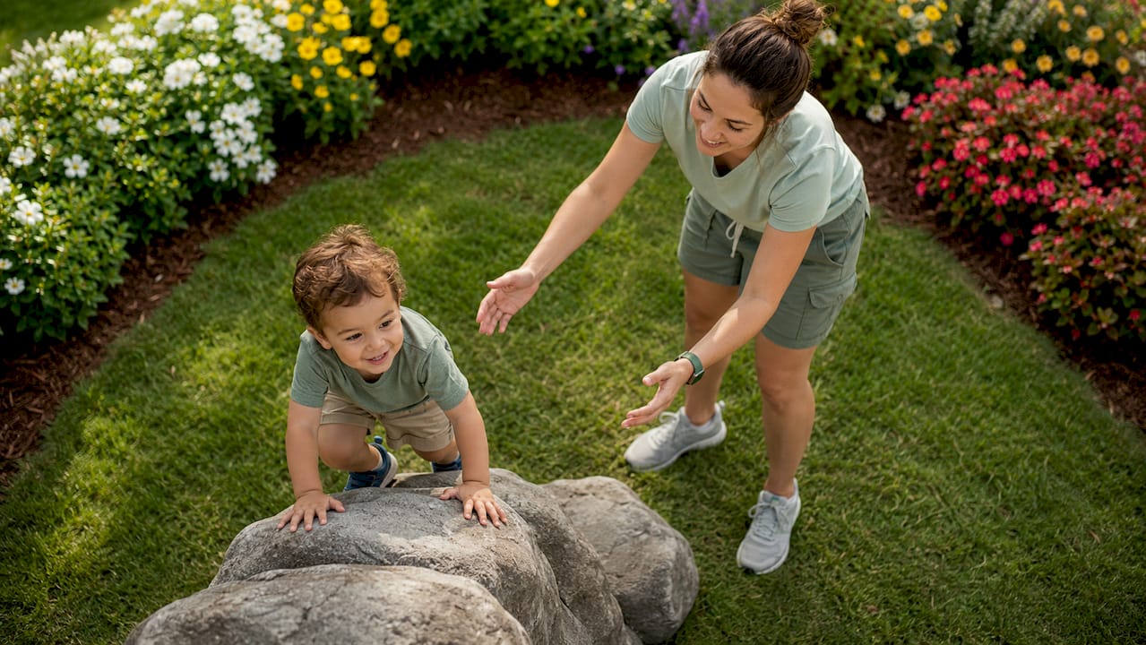 Therapist guiding toddler through physical therapy exercises