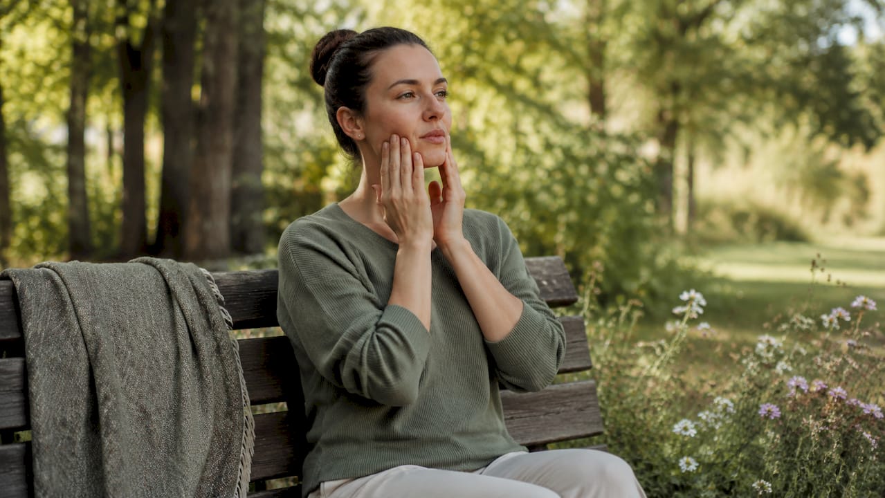 Woman performing jaw sliding exercises at home