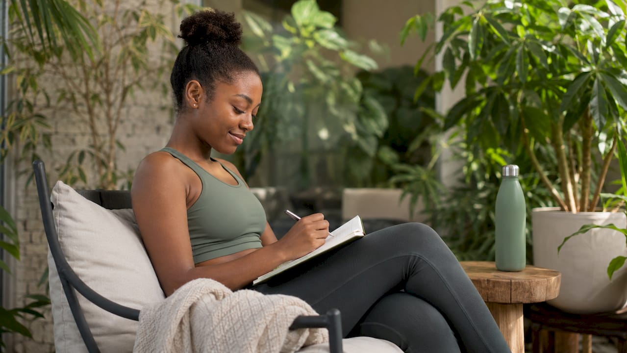 Woman at home tracking physical therapy exercises