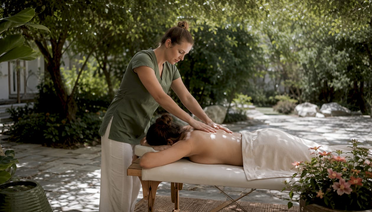 Therapist performing therapeutic massage on client back