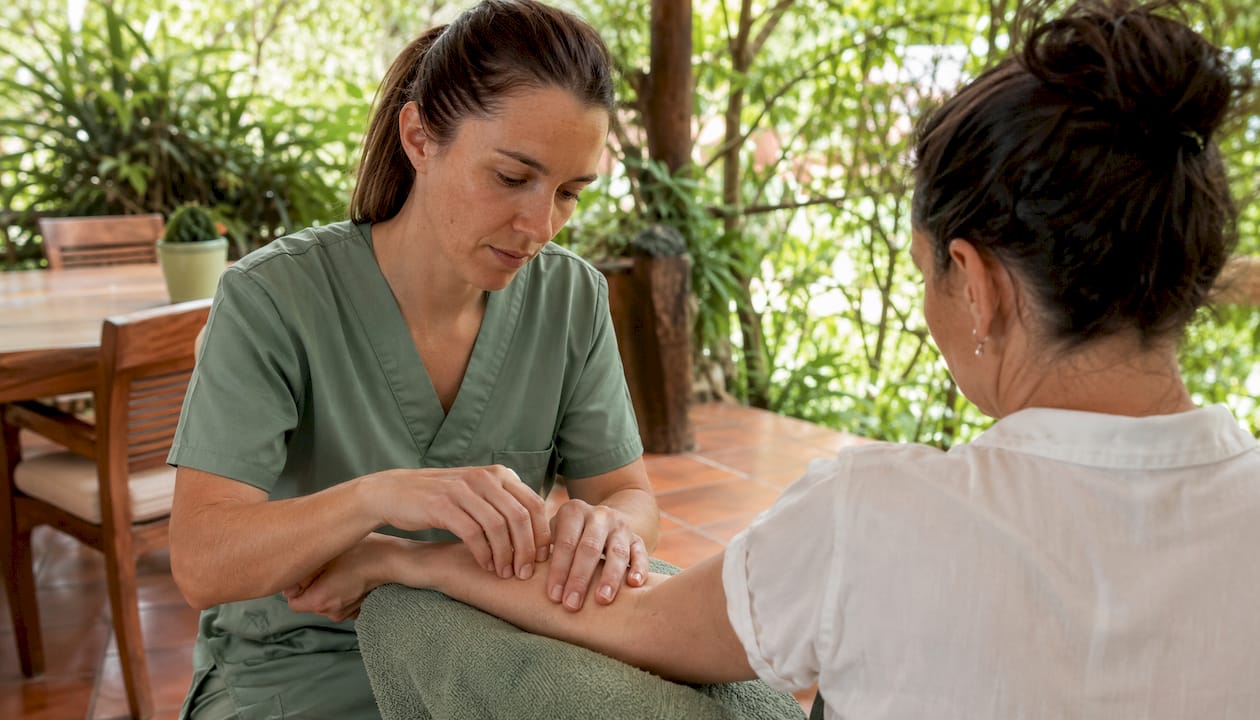 Therapist hands administering manual therapy treatment