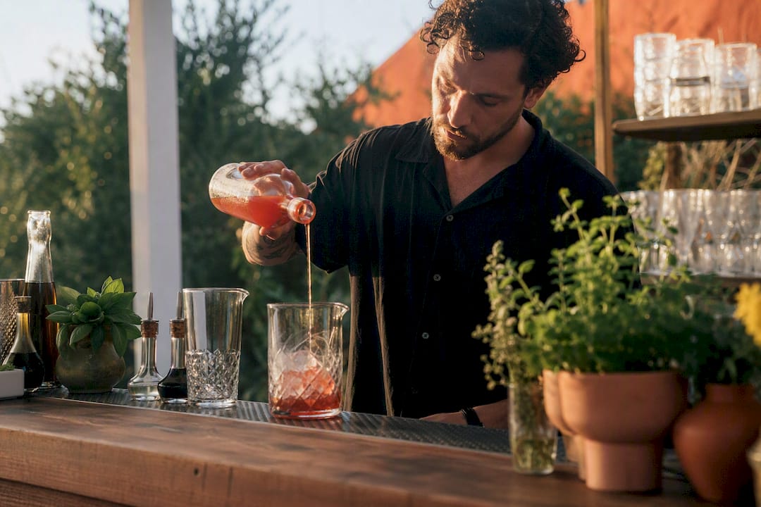 Bartender pouring cocktail at upscale event