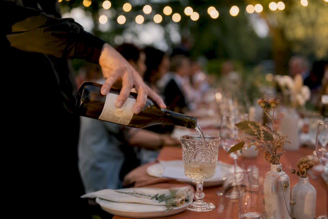 Server pouring wine at luxury gala