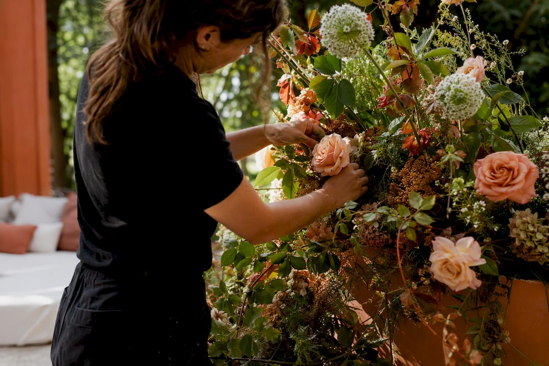 Florist hands installing gala floral display