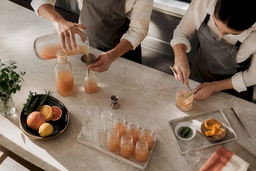 Bartenders preparing batched and fresh cocktails