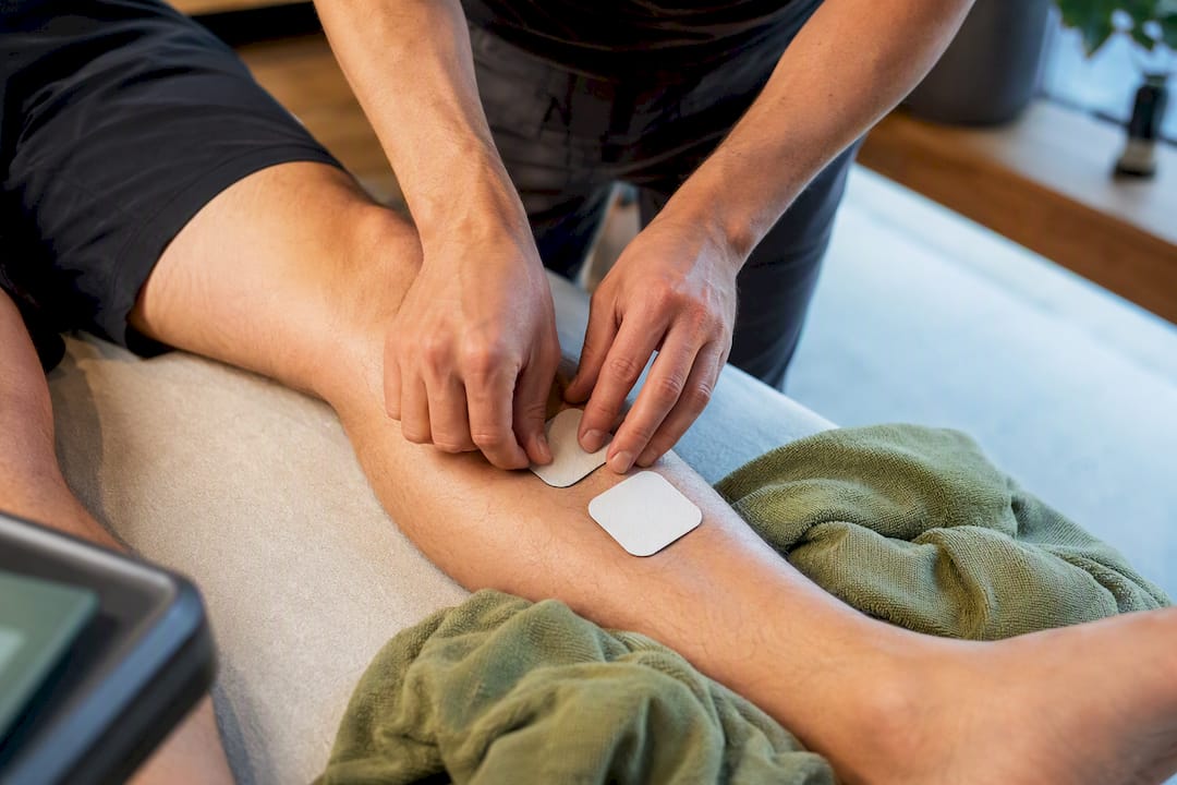 Therapist positioning stimulation electrodes on lower leg