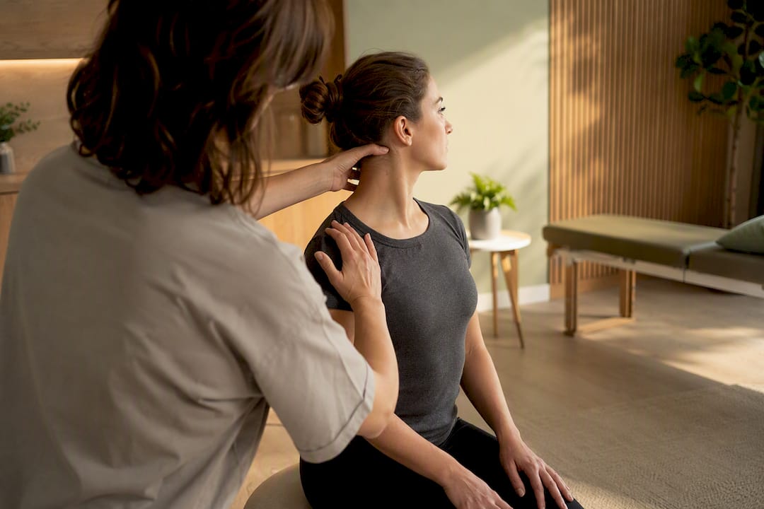 Therapist guiding controlled neck movement