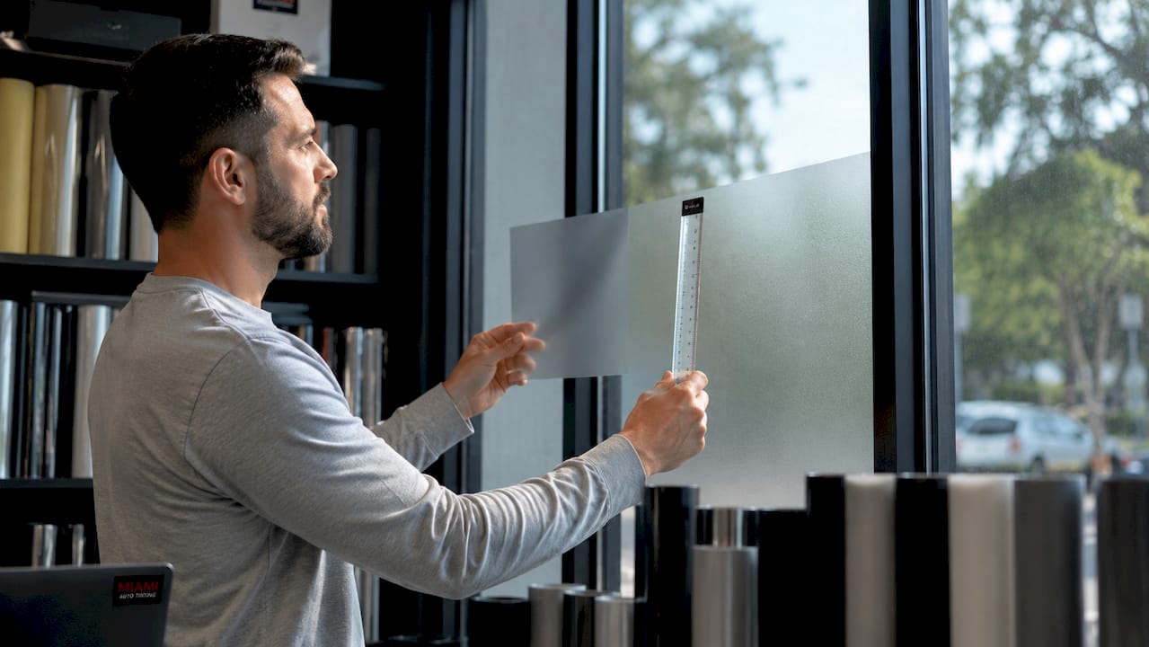 Technician demonstrates window film privacy scale