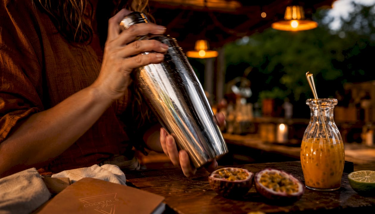 Shaking the ingredients well with the shaker firmly in hand.