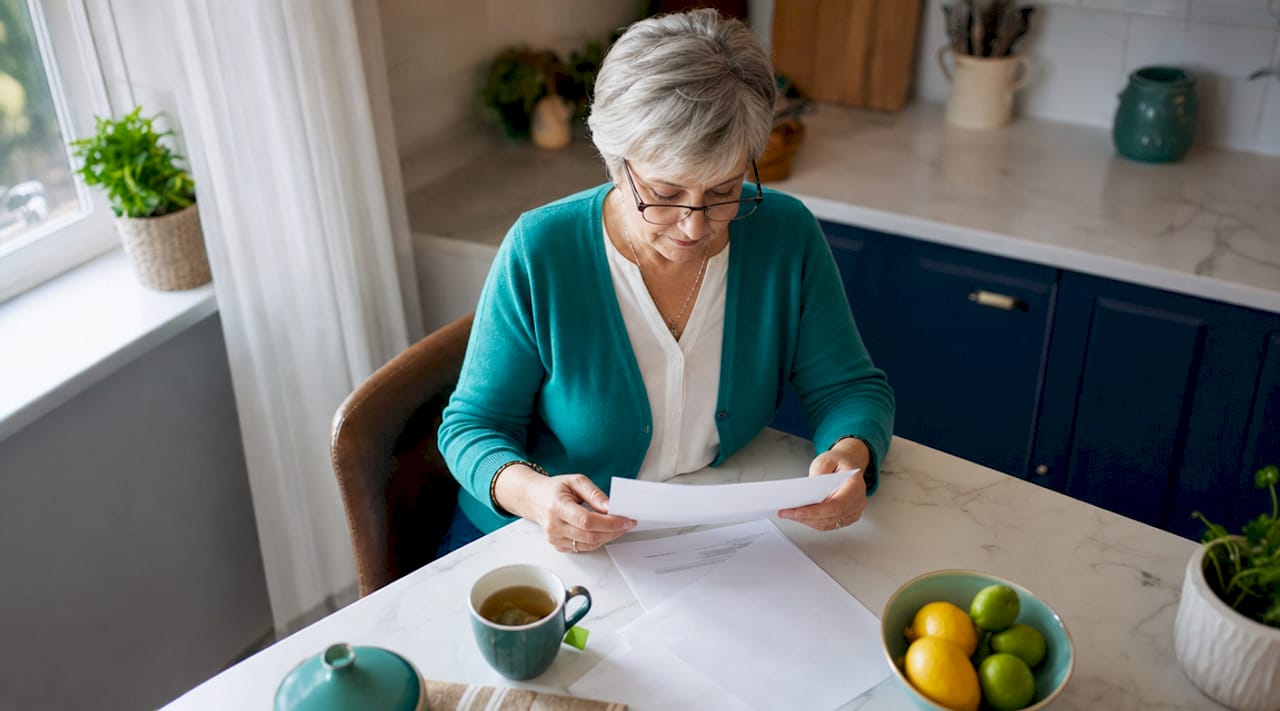 Senior woman reviewing personal legal documents at home