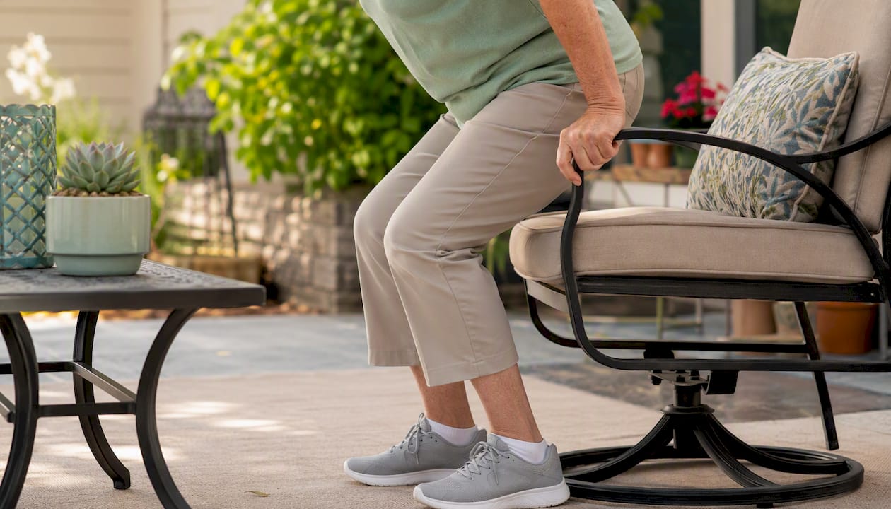 Senior performing chair stand exercise at home