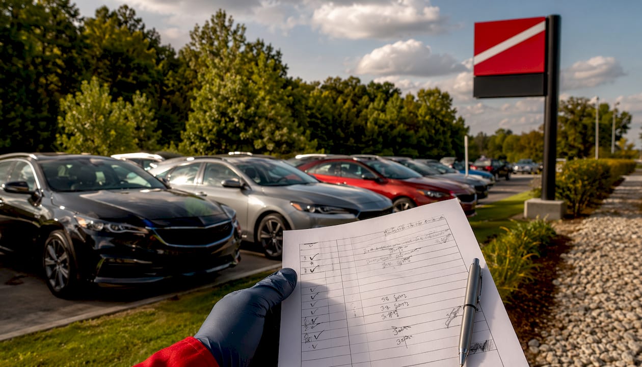 Checklist and dealership signage close-up inspection