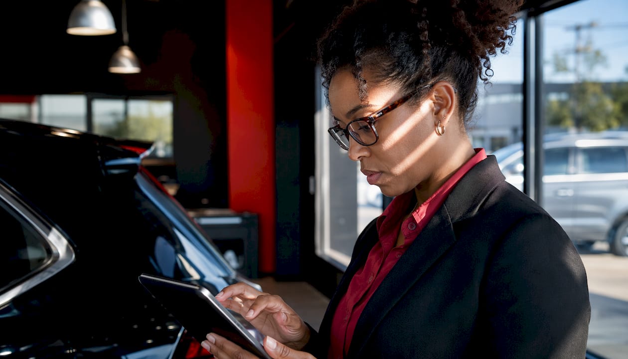Employee reviewing vehicle inspection report on tablet