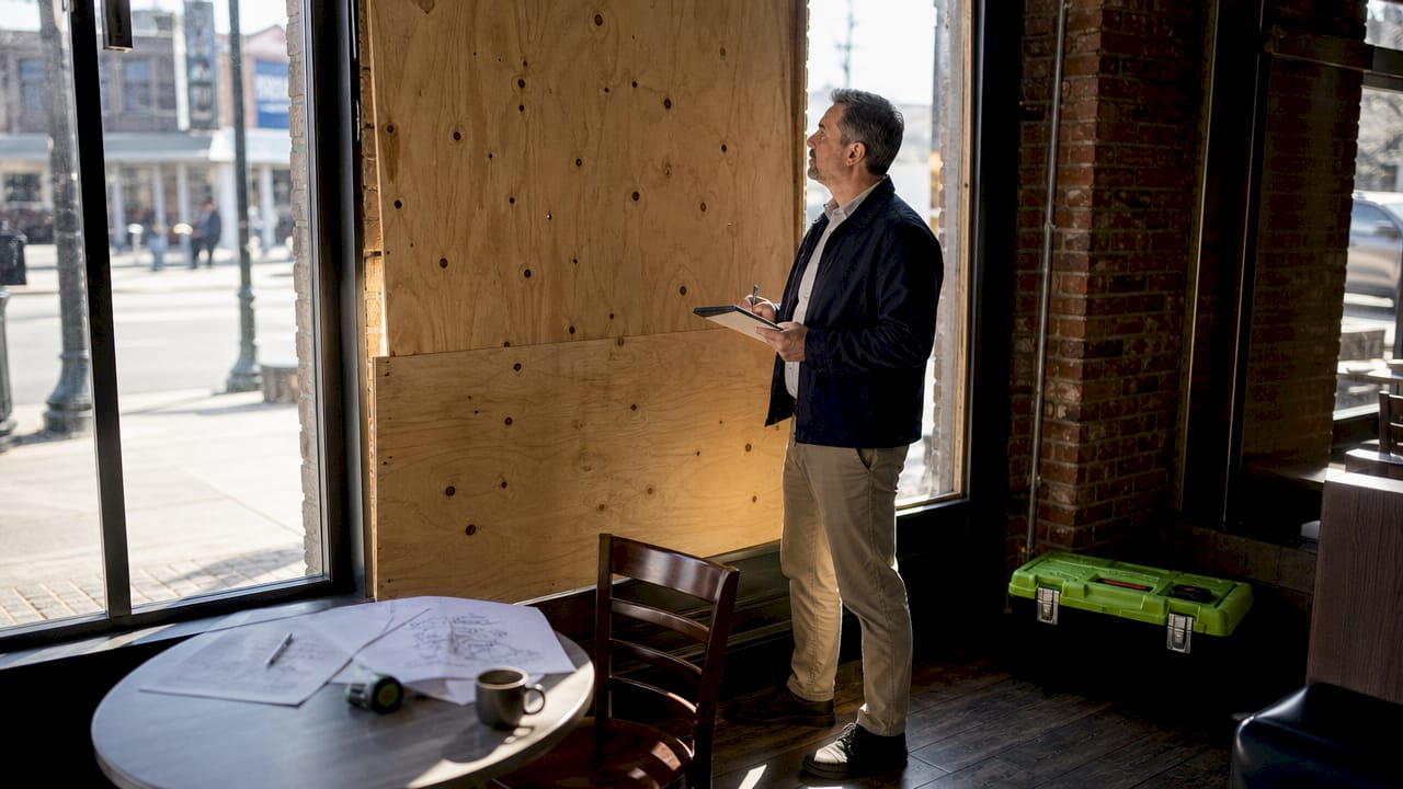Business owner inspecting damaged property interior