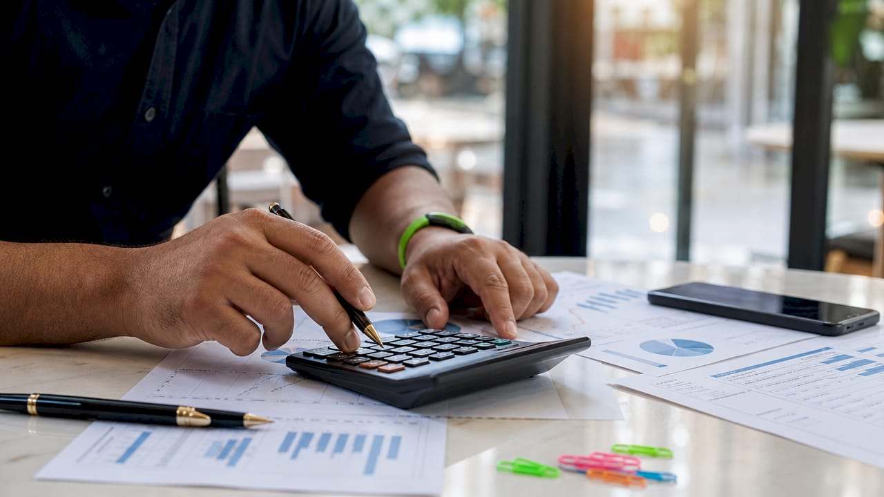 Close-up of hands calculating insurance financial reports