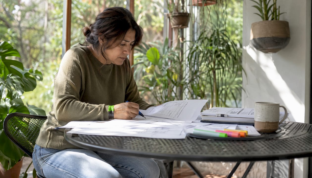 Property owner studying alteration plans at home desk