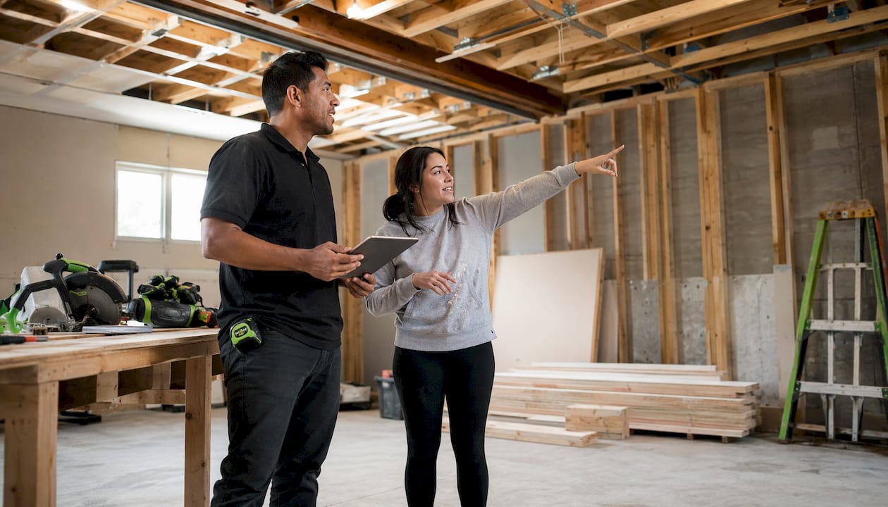 Contractor and homeowner discussing basement conversion