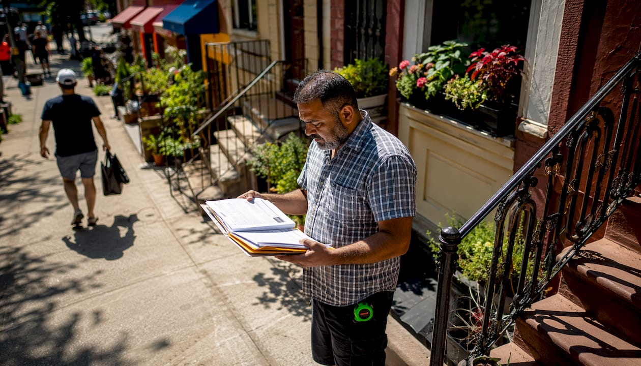 Bronx property owner reviewing contractor bids outdoors
