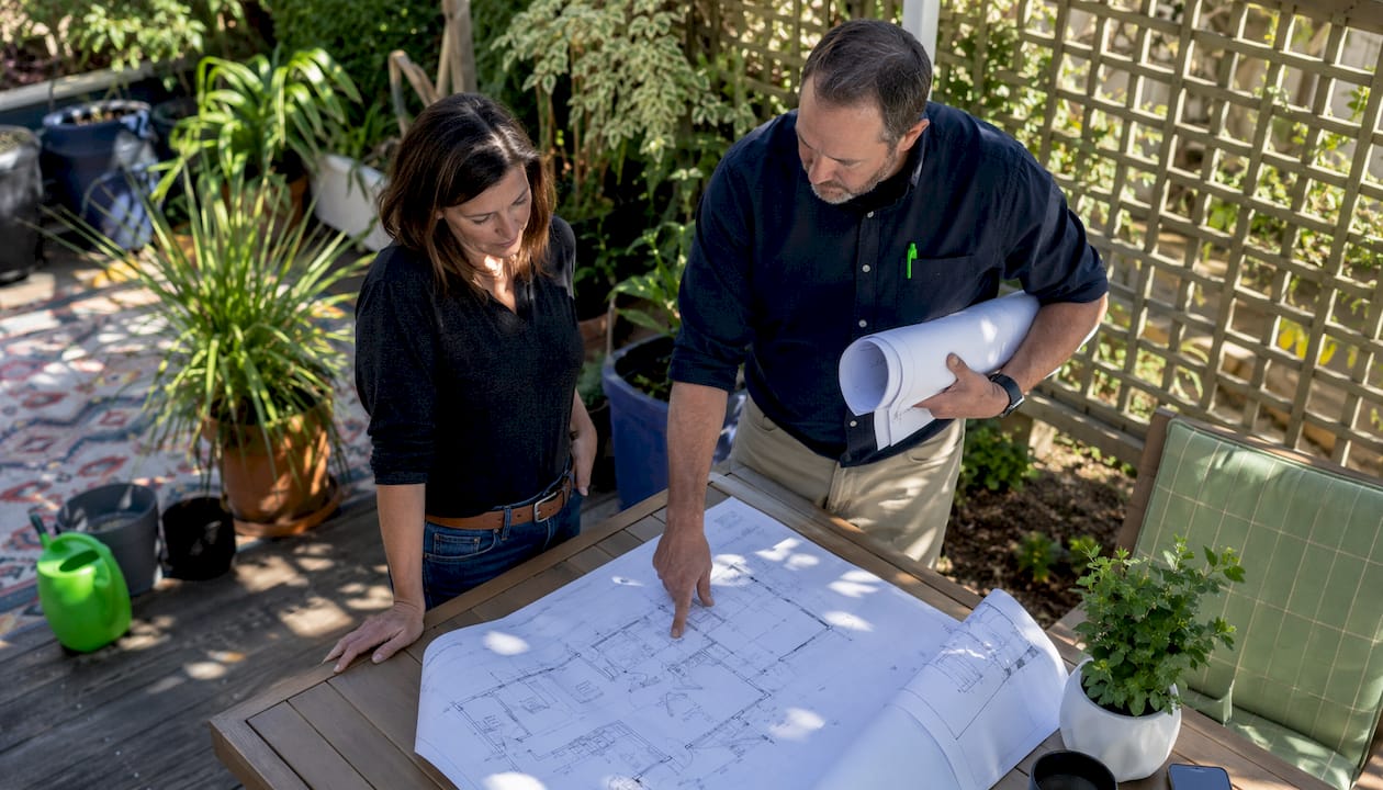 Homeowner and architect reviewing remodeling plans