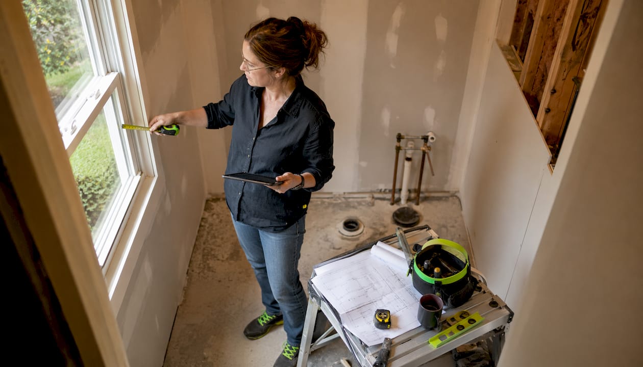 Interior designer measuring small half bath space