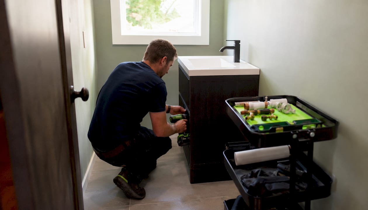 Carpenter fitting half bath vanity and sink